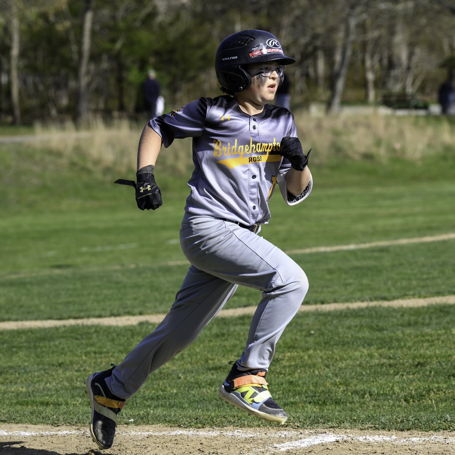Bridgehampton seventh-grader Finn Alversa legs out a base hit.   MARIANNE BARNETT