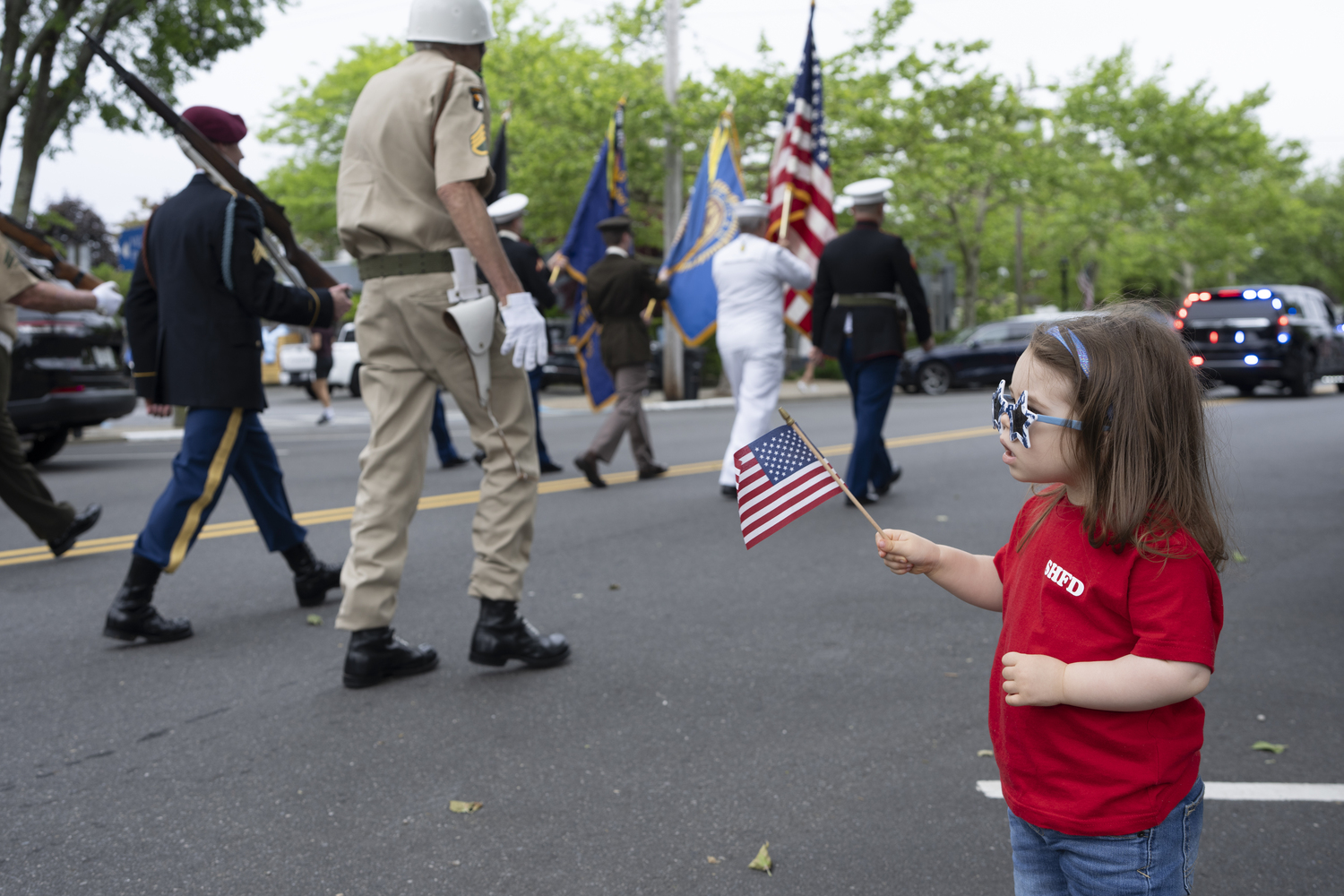 A young girl watches the Sag Harbor Memorial Day parade pass by. LORI HAWKINS