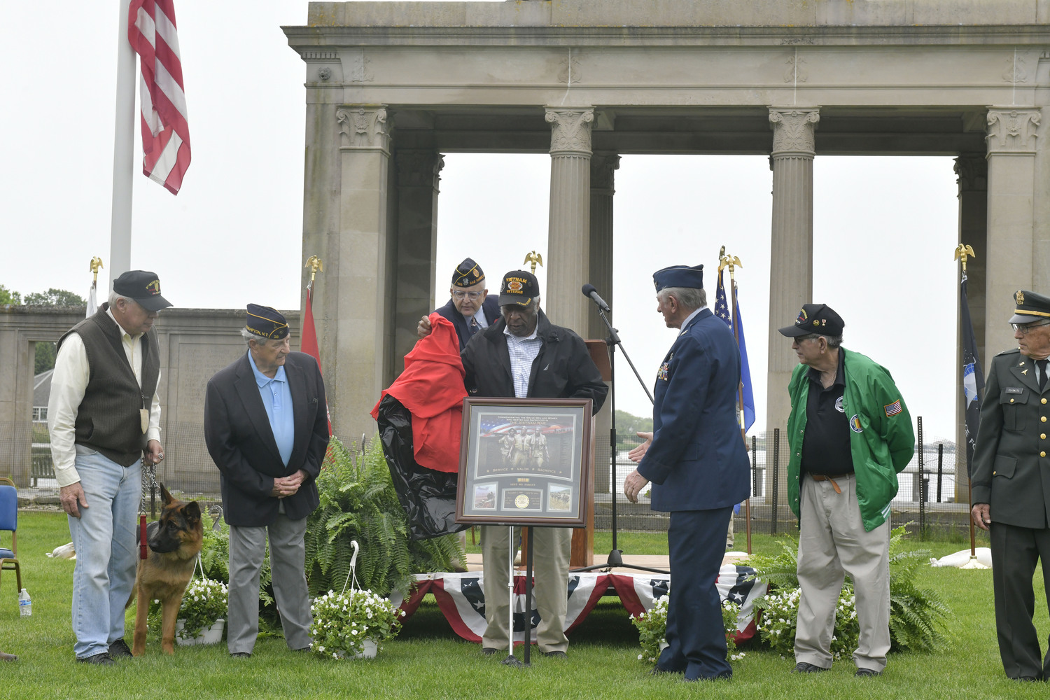 Vietnam Veteran Alvin Woods unveils the plaque honoring Vietnam Veterans which will be hung in Veterans Hall.