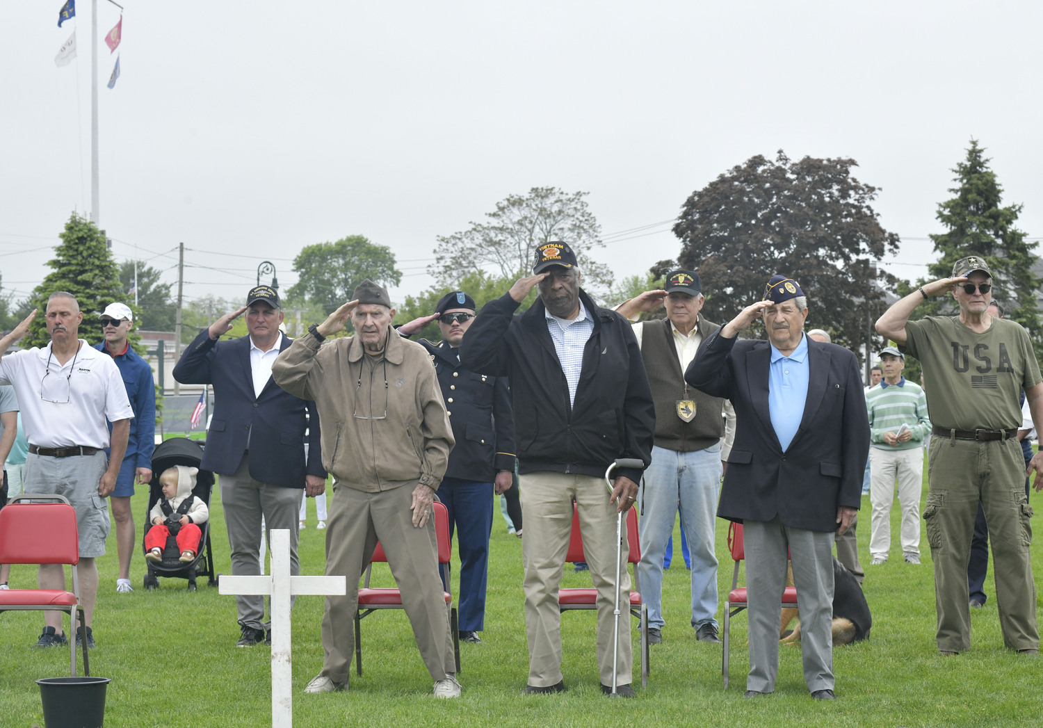 Veterans salute at memorial Day services in Agawam Park on Monday.