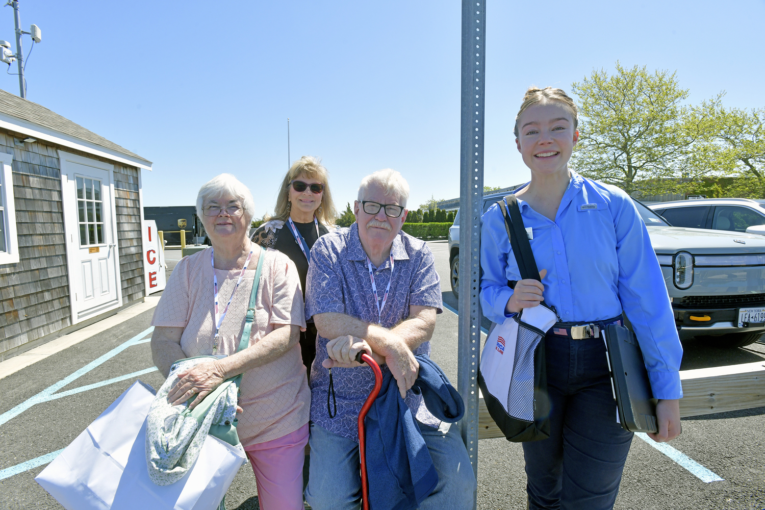 American Cruise Line passengers Joy Sweeney from Antelope, Ca, Kay Rensvold from Pattison TX and Ed Sweeney, also from antelope, with cruise and excursion director Karis Borchelt, wait for the launch back to their ship at the dock in Sag Harbor on Tuesday.  DANA SHAW