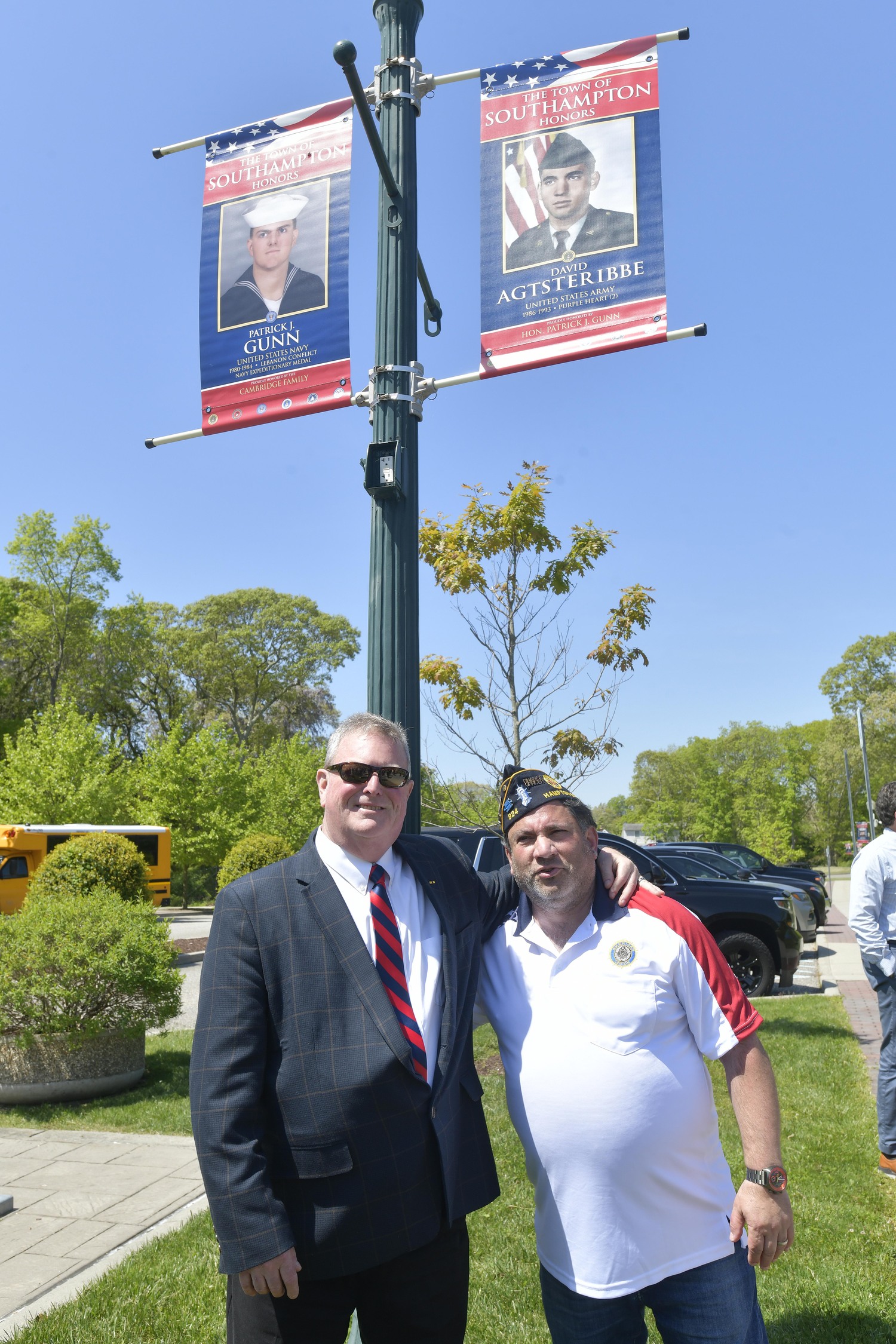 Southampton Town Justice Pat Gunn and David Agsteribbe of the Hampton Bays American Legion with their banners.  DANA SHAW