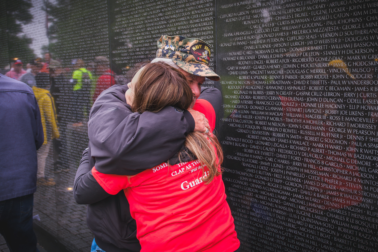 Vietnam veteran Thomas Coughlin embraces his daughter, Kate Caporusso, at the Vietnam Veterans Memorial in Washington, D.C. MARK CHAMBERLAIN
