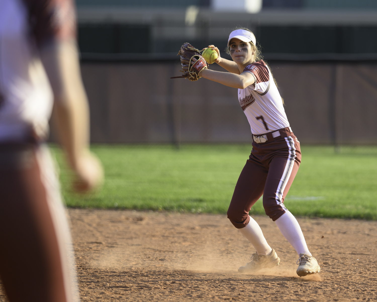 East Hampton second baseman Colleen McKee throws to first for an out. MARIANNE BARNETT