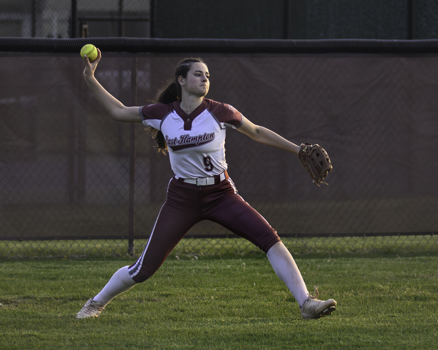 Gabrielle Payne throws the ball back in after catching a fly ball in left field. MARIANNE BARNETT