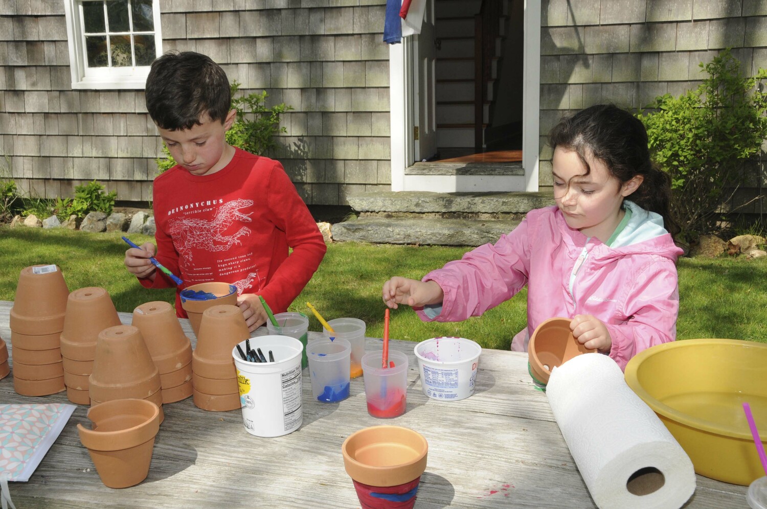 Easton Martin and Claire Kochanasz Asz paint flower pots for Mother's Day gifts on Saturday at the East Hampton Town Historical Farm Museum. John Marshall Elementary School students were invited to paint a flower pot and plant a flower for Mom on Mother's Day,  Alice Wood curated the event.  RICHARD LEWIN