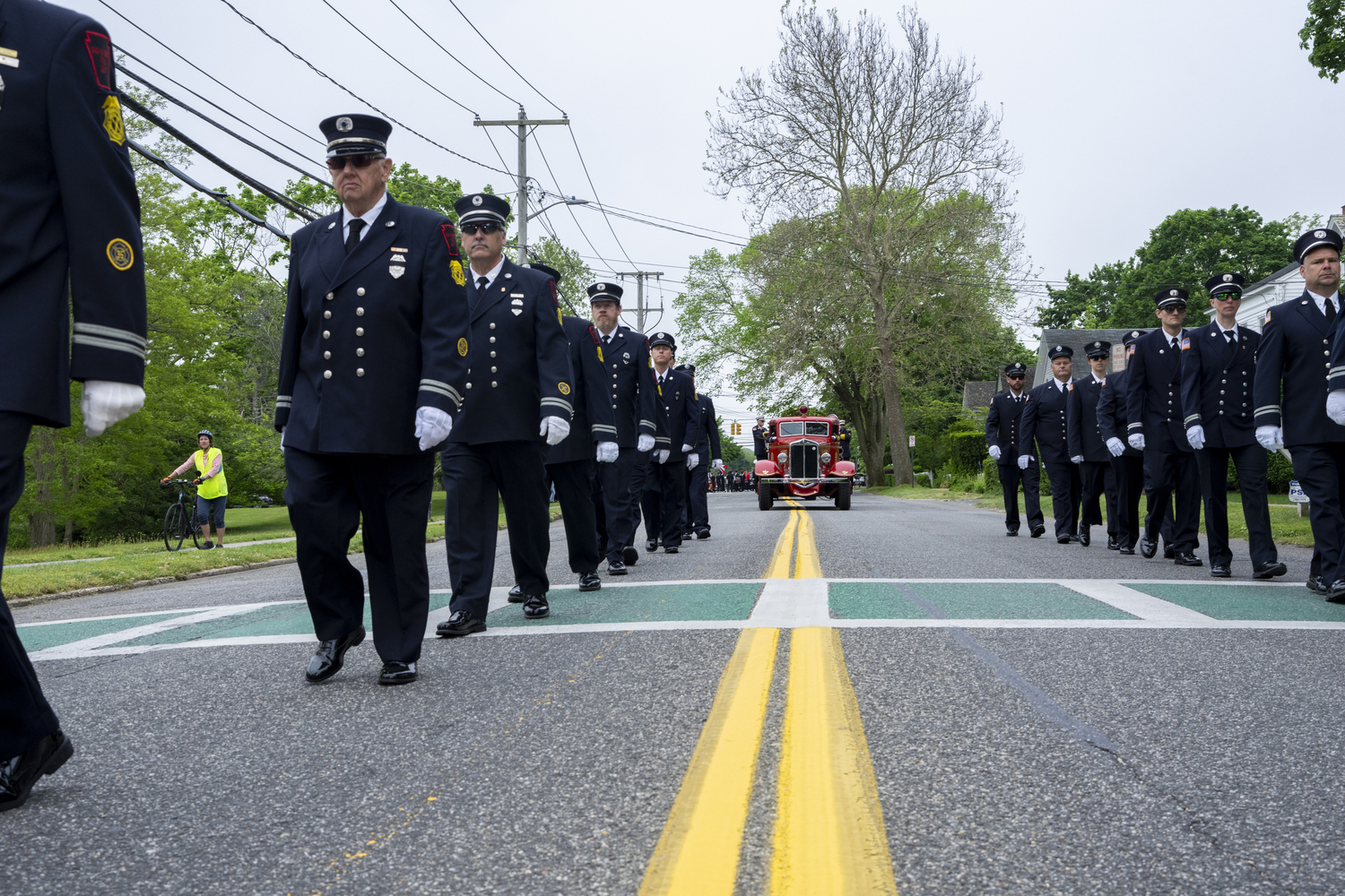 Members of the Sag Harbor Fire Department, followed by an antique truck, march in the village's annual Memorial Day Parade. LORI HAWKINS