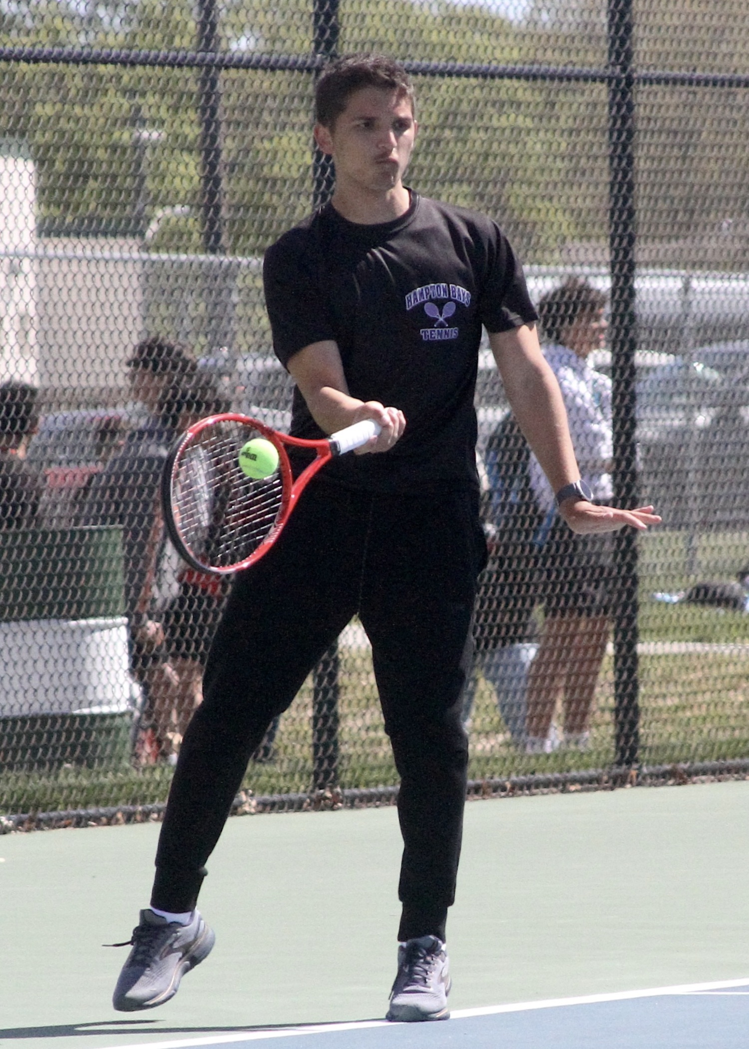 Hampton Bays junior Chris Clinton sends the ball back over the net. DESIRÉE KEEGAN