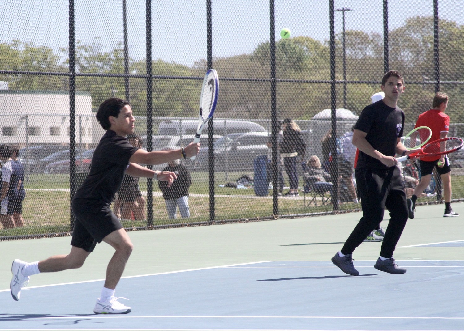 Hampton Bays junior Kevin David Saa Pacheco returns the ball with Division IV doubles partner, junior Chris Clinton, at his side. DESIRÉE KEEGAN