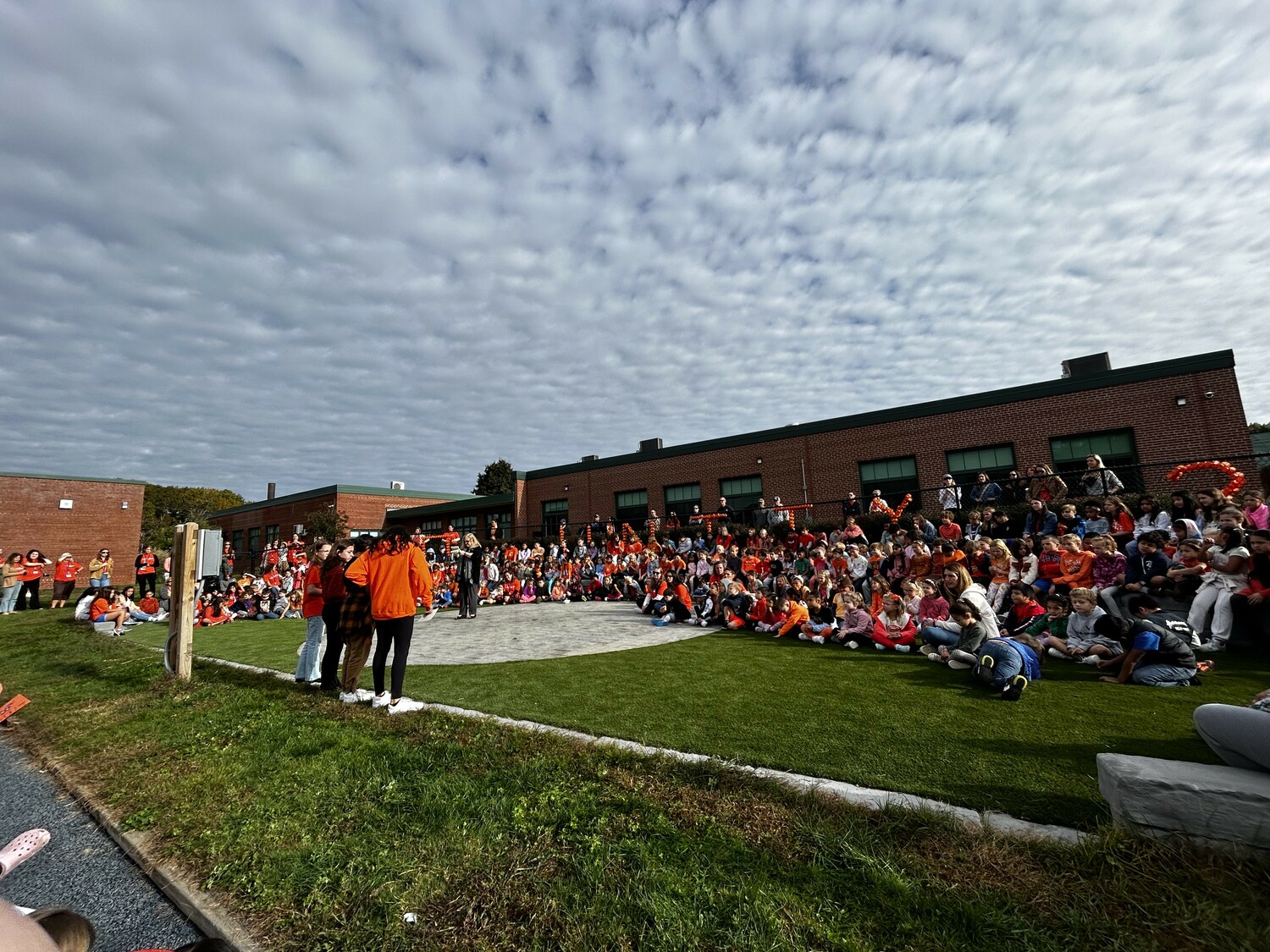 East Quogue School students during a whole school meeting at the school's outdoor amphitheater.