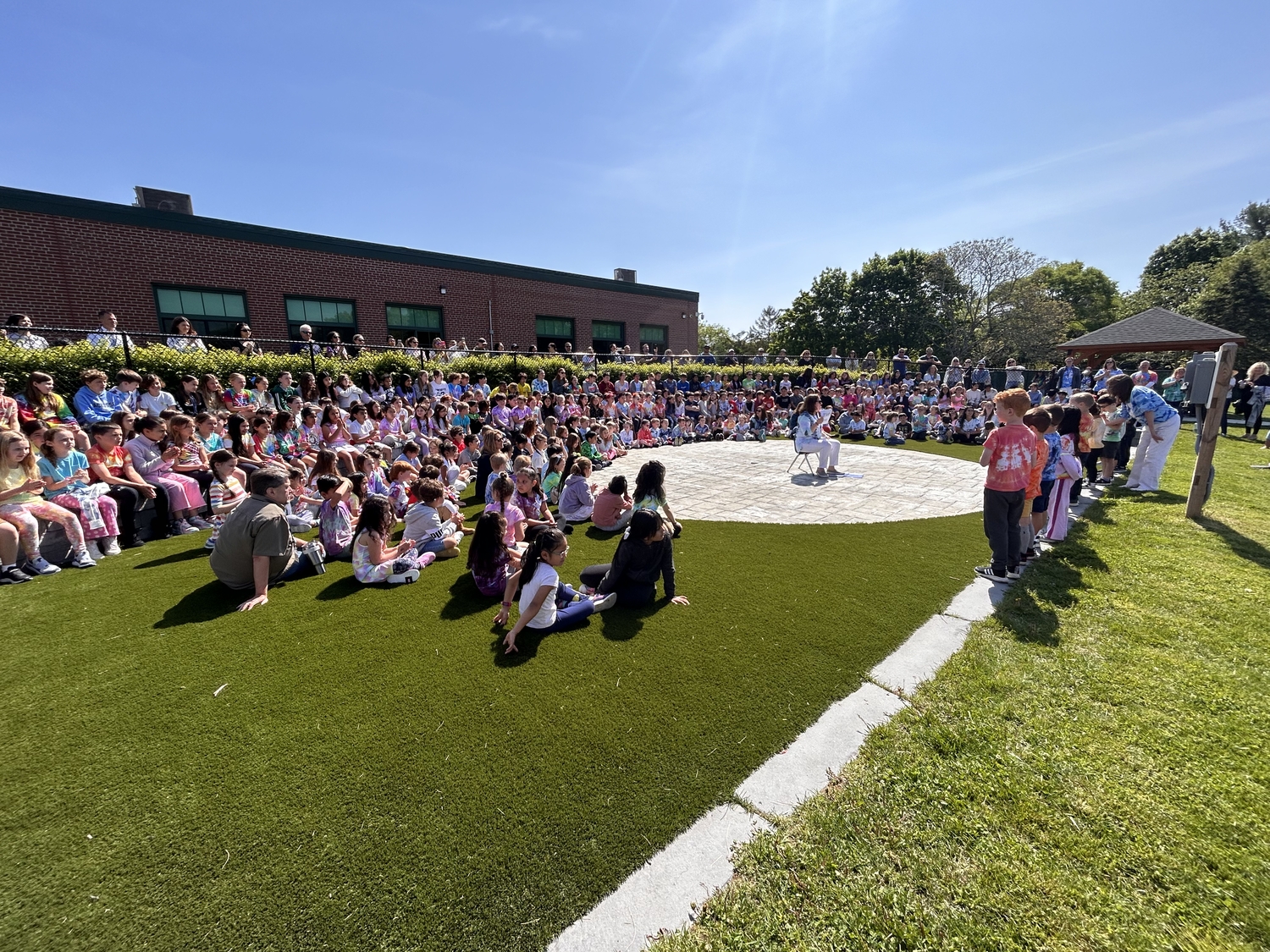 East Quogue School students during a whole school meeting at the school's outdoor amphitheater.