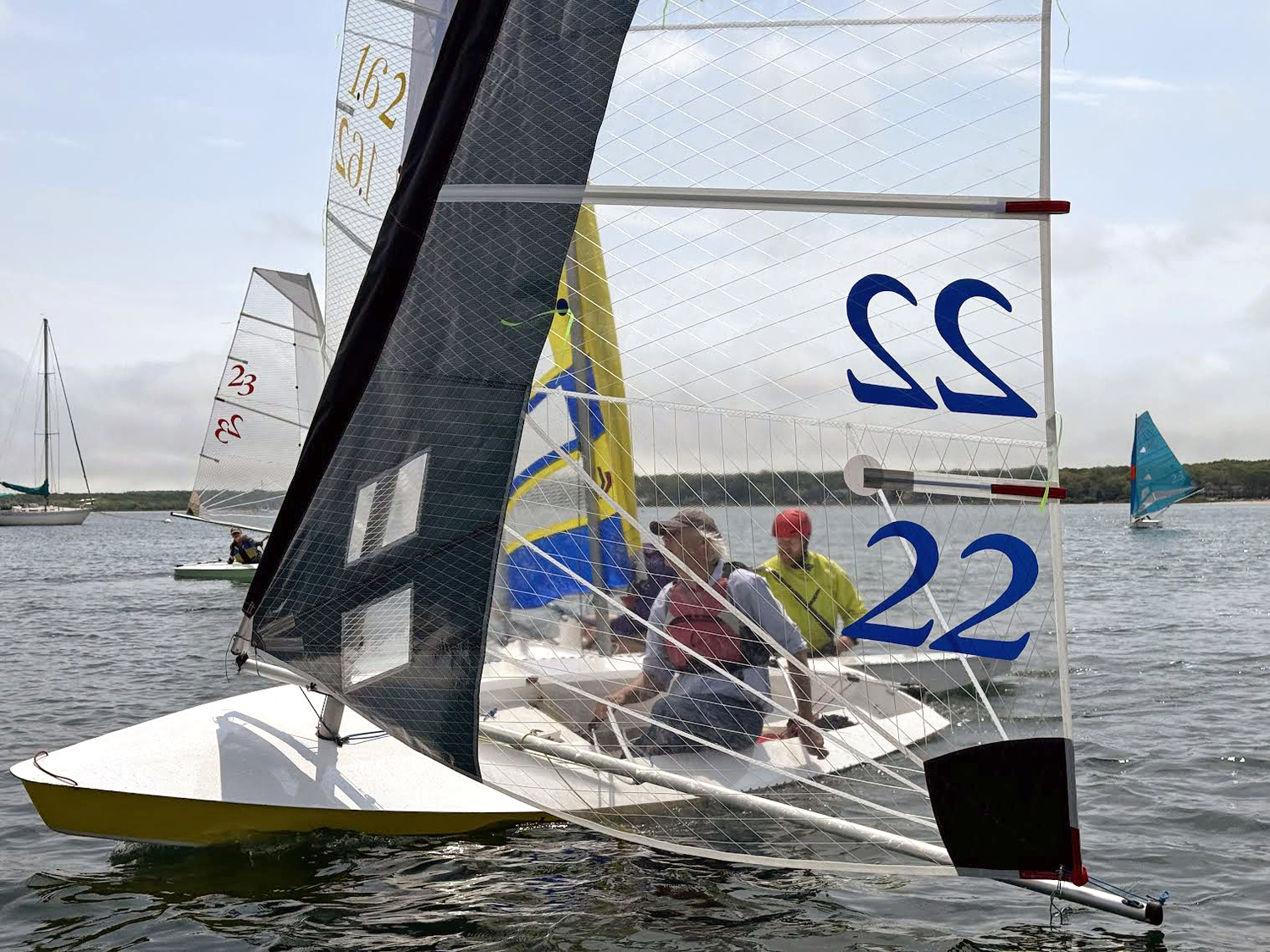 Scott Sandell, sporting a new sail he recently cut and sewed in his kitchen, slipping by his competitors’ boats moments before the first start.   MICHAEL MELLA