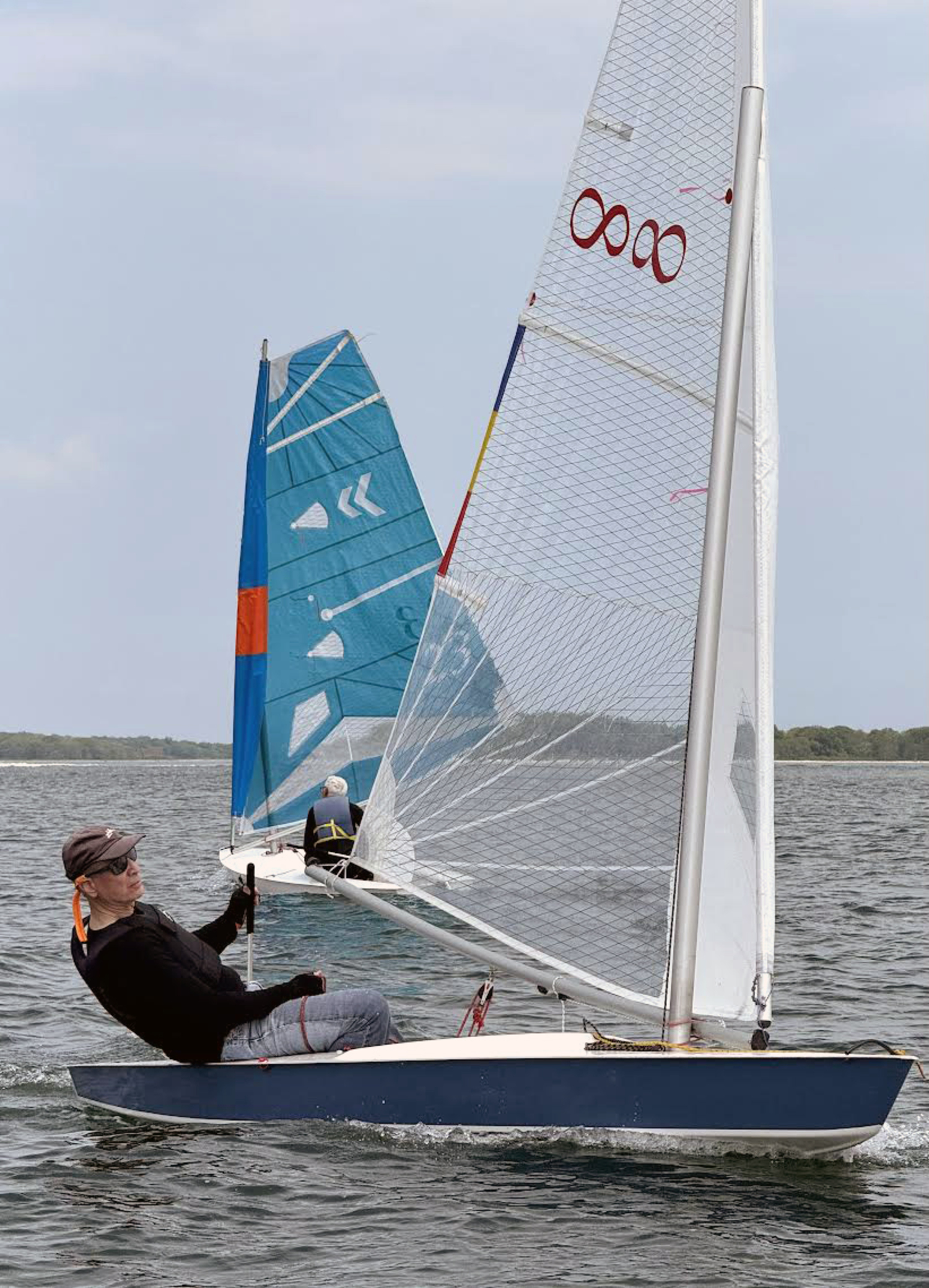 Sag Harbor architect Jim Merrell working his way close-hauled to the finish line while Richard Coles broad-reaches for the leeward mark.  MICHAEL MELLA