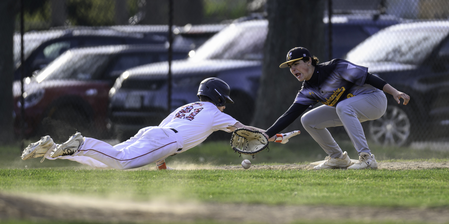 Pierson's Evan Mitchell dives back to first while Bridgehampton first baseman Elliot McGonegal tries to pick a ball in the dirt.  MARIANNE BARNETT
