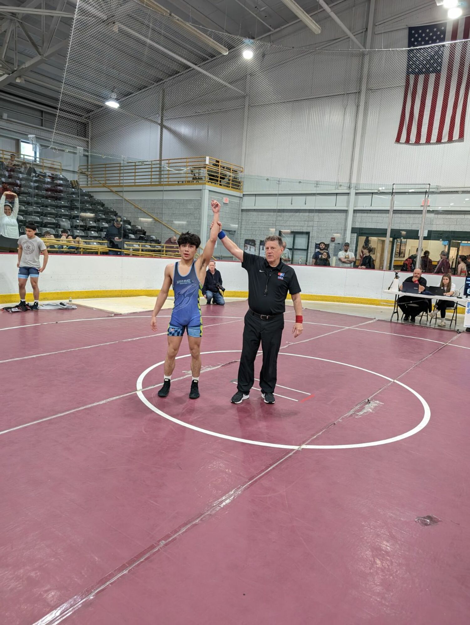 Juan Roque gets his hand raised after winning the 120-pound class at the New York State Greco-Roman Championships.    COURTESY ETHAN MITCHELL