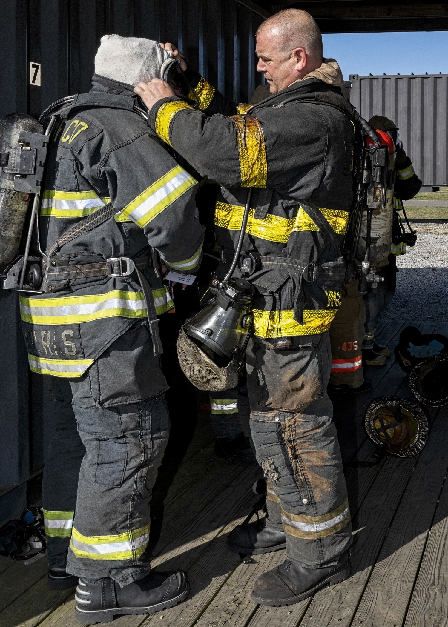 Instructor checks participant's mask before his rotation in the hot box. JOHN NEELY