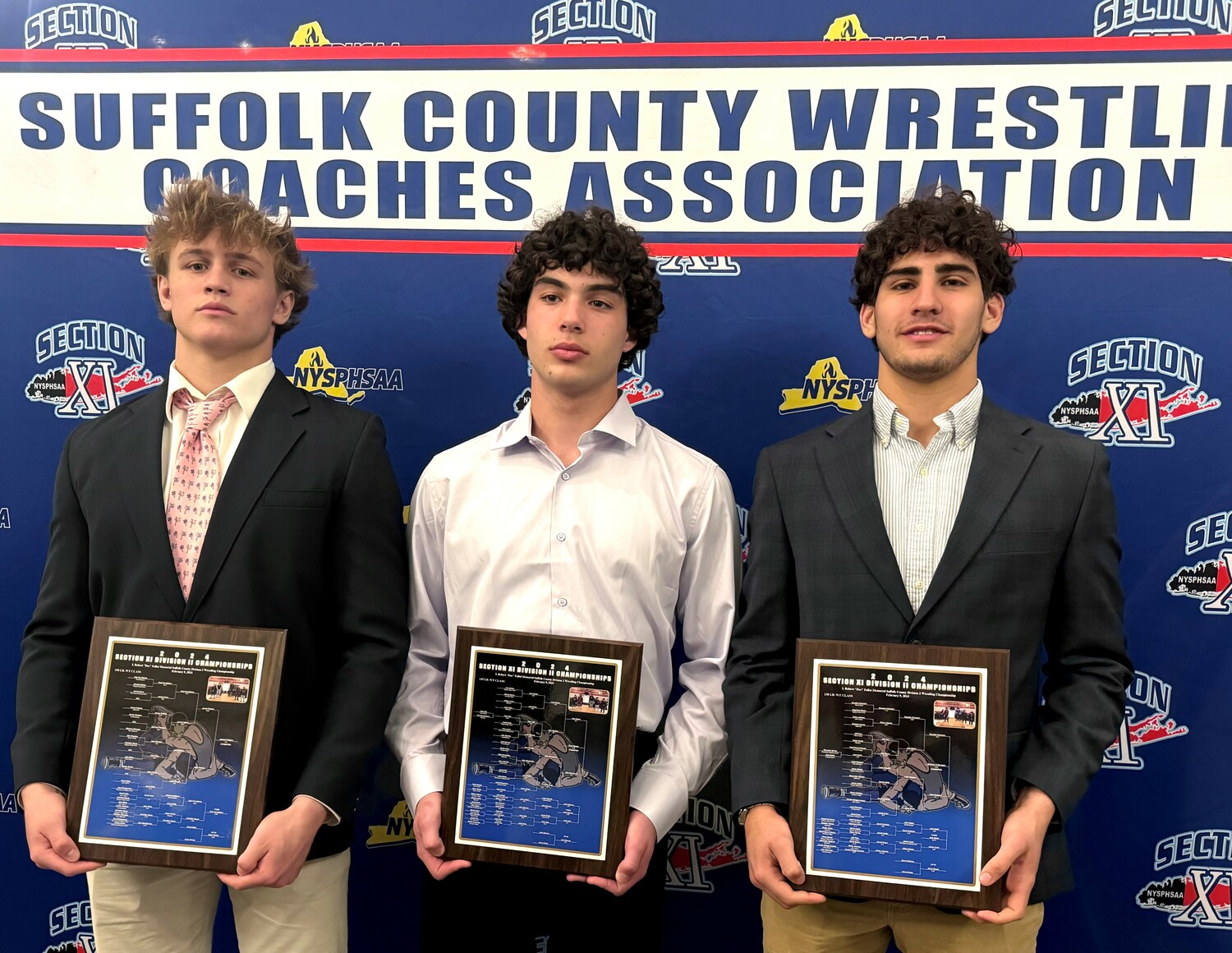 Cole Fox, left, Liam Squires and Jack Nastri at the Suffolk County Wrestling Coaches Association Dinner on April 17. Hudson Fox was not in attendance but was also honored.   ERIC NASTRI