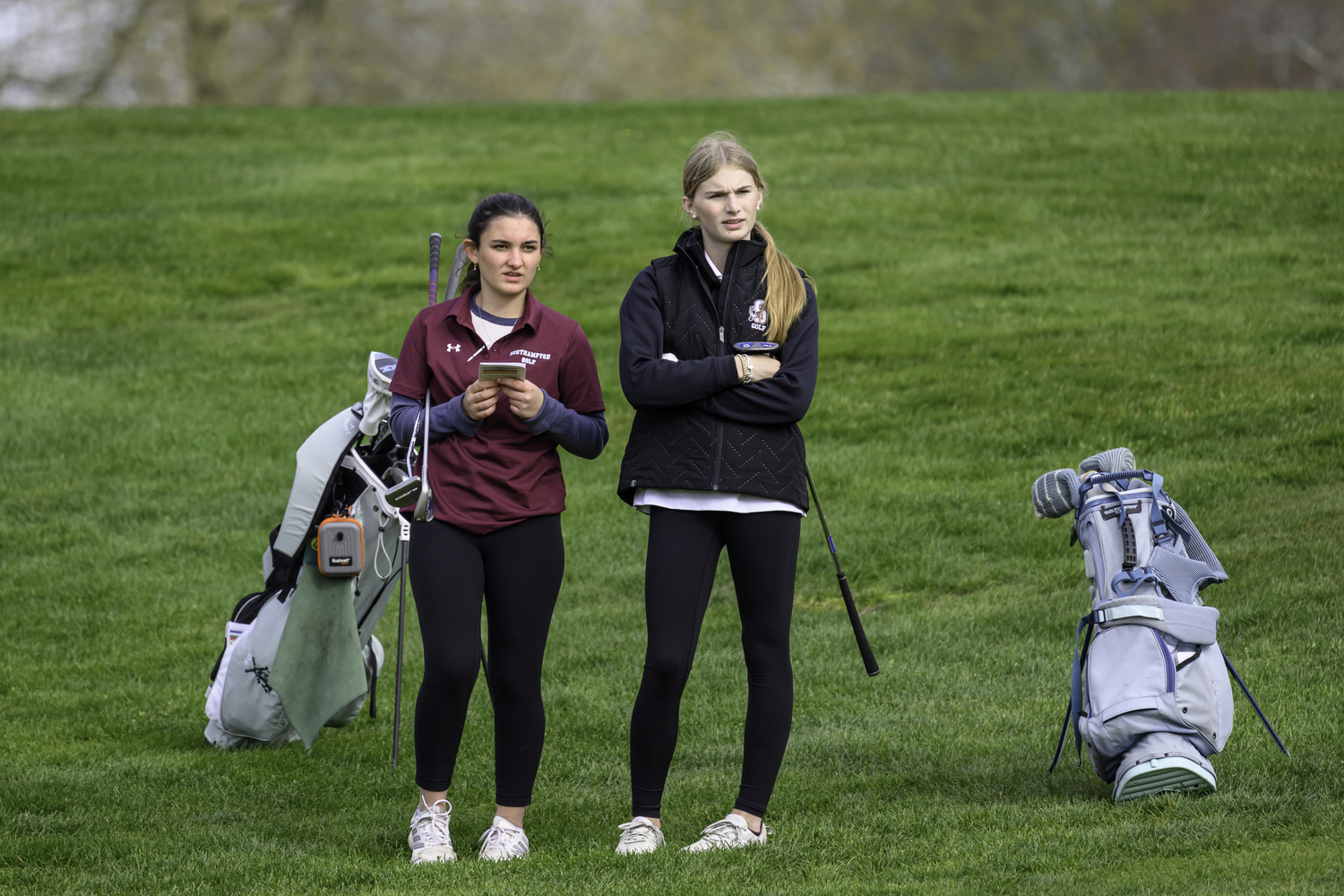 Georgia Wilutis, left, and Jillian Swiatocha go over strategy during a match on Thursday, May 2.  MARIANNE BARNETT