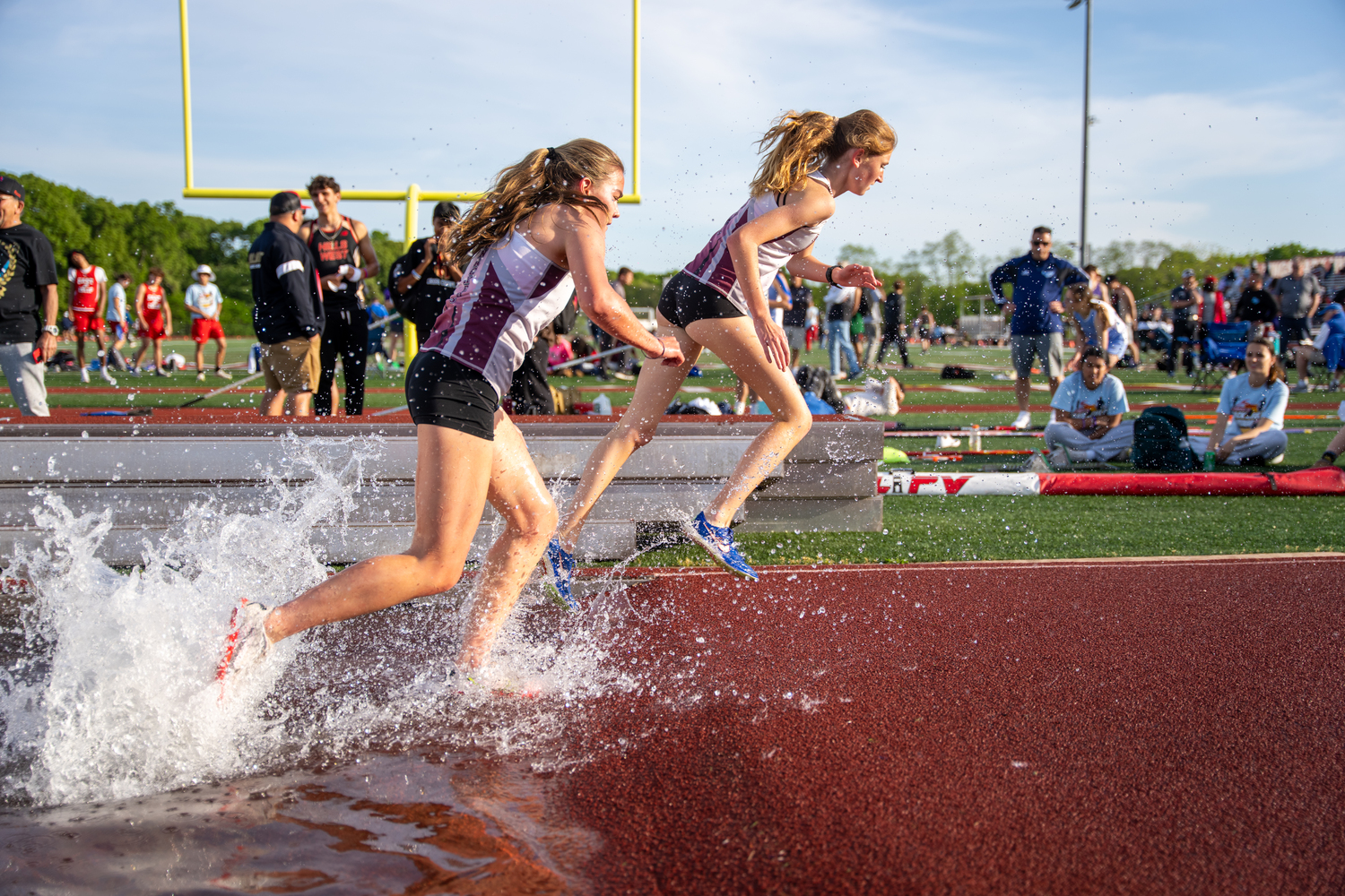 Sara O'Brien is first out of the water pit, then teammate Greylynn Guyer in the 2,000-meter steeplechase. RON ESPOSITO