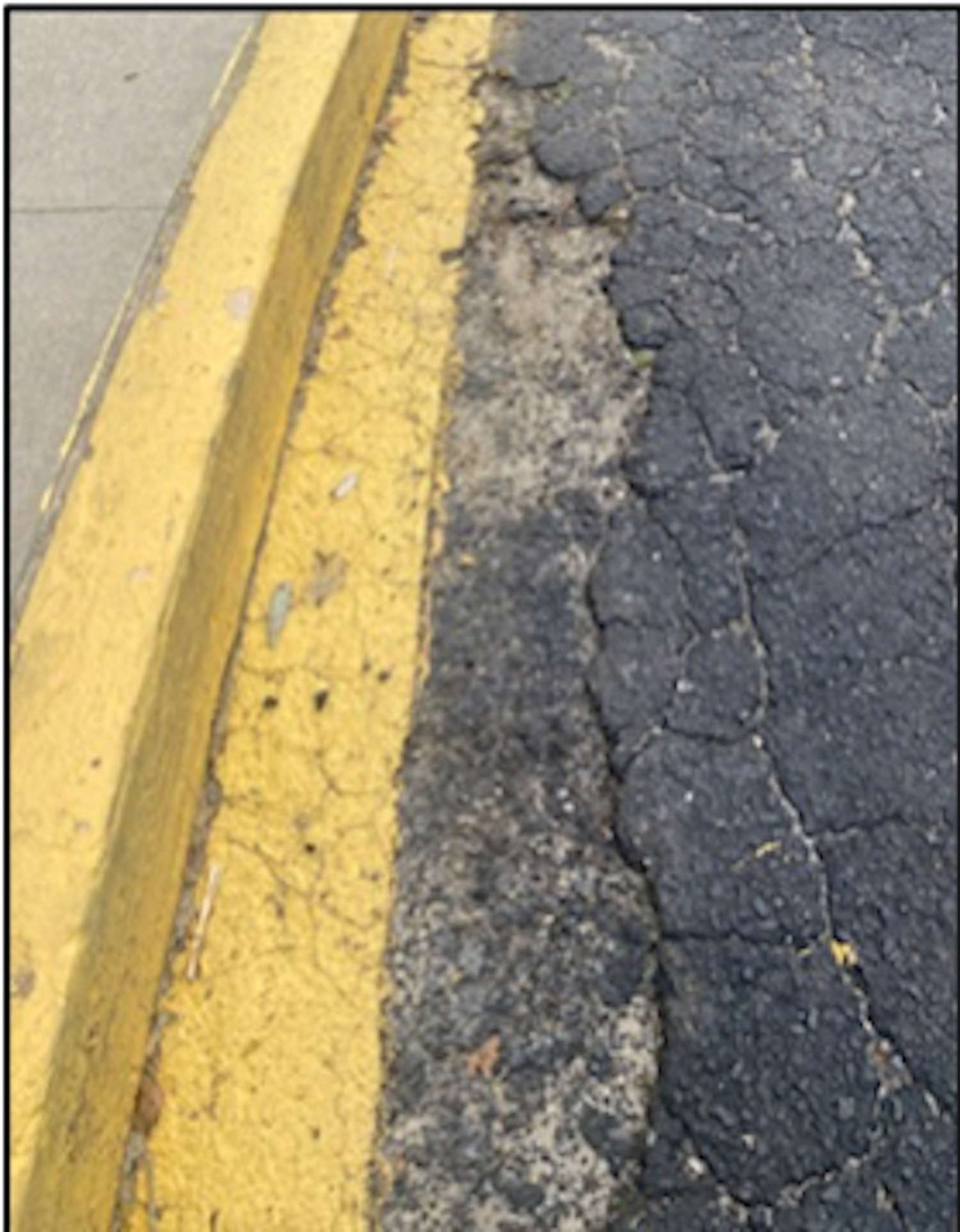 The Springs School bus loop asphalt is cracking and eroding away from the sidewalk.