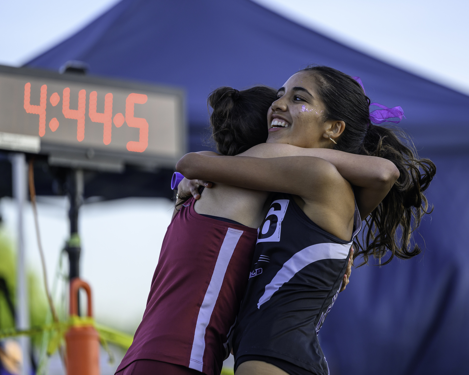 Southampton's Emma Suhr and Sofia Galvan of Hampton Bays hug each other after the end of the 4x400-meter relay.   MARIANNE BARNETT