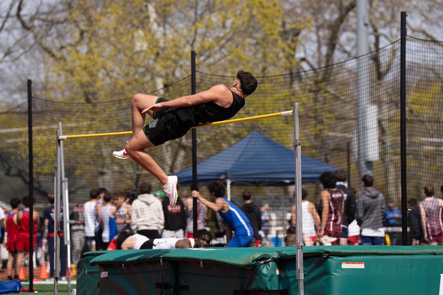 Westhampton Beach senior Michael LoRusso competing in the high jump at his school's invitational on Saturday. RON ESPOSITO