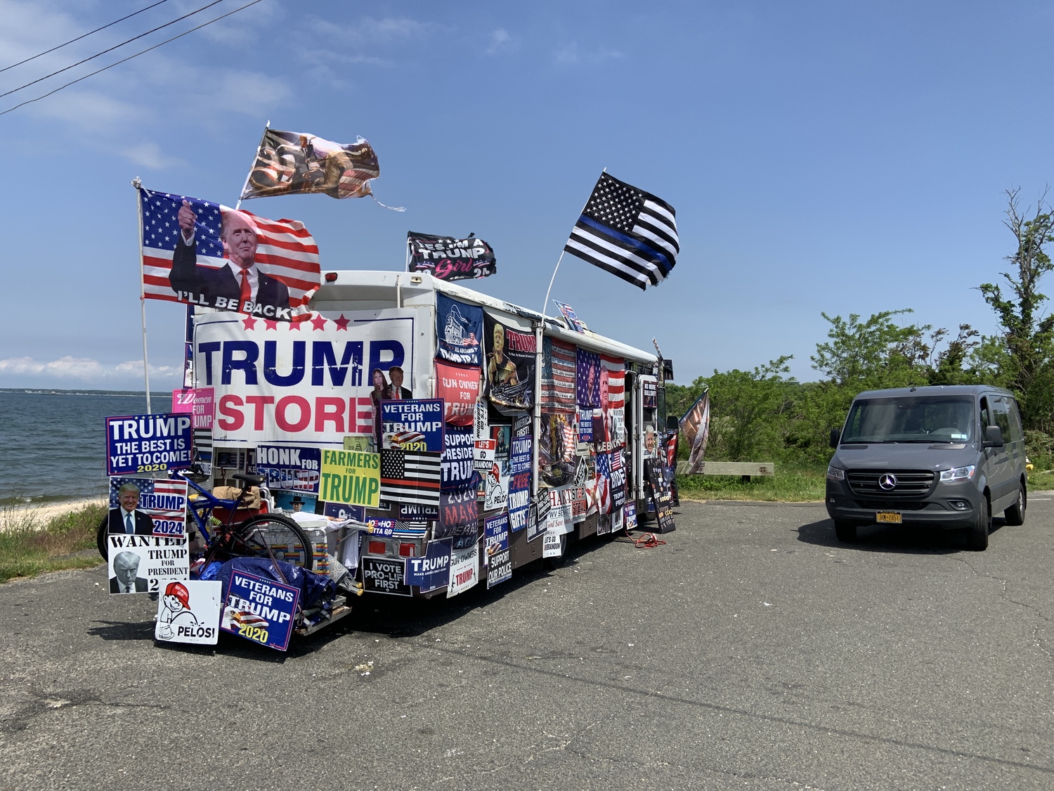 An RV festooned with Donald Trump signs and flags and laden with pro-Trump merchandise inside was stranded on the side of Long Beach Road in Noyac on Tuesday. STEPHEN J. KOTZ