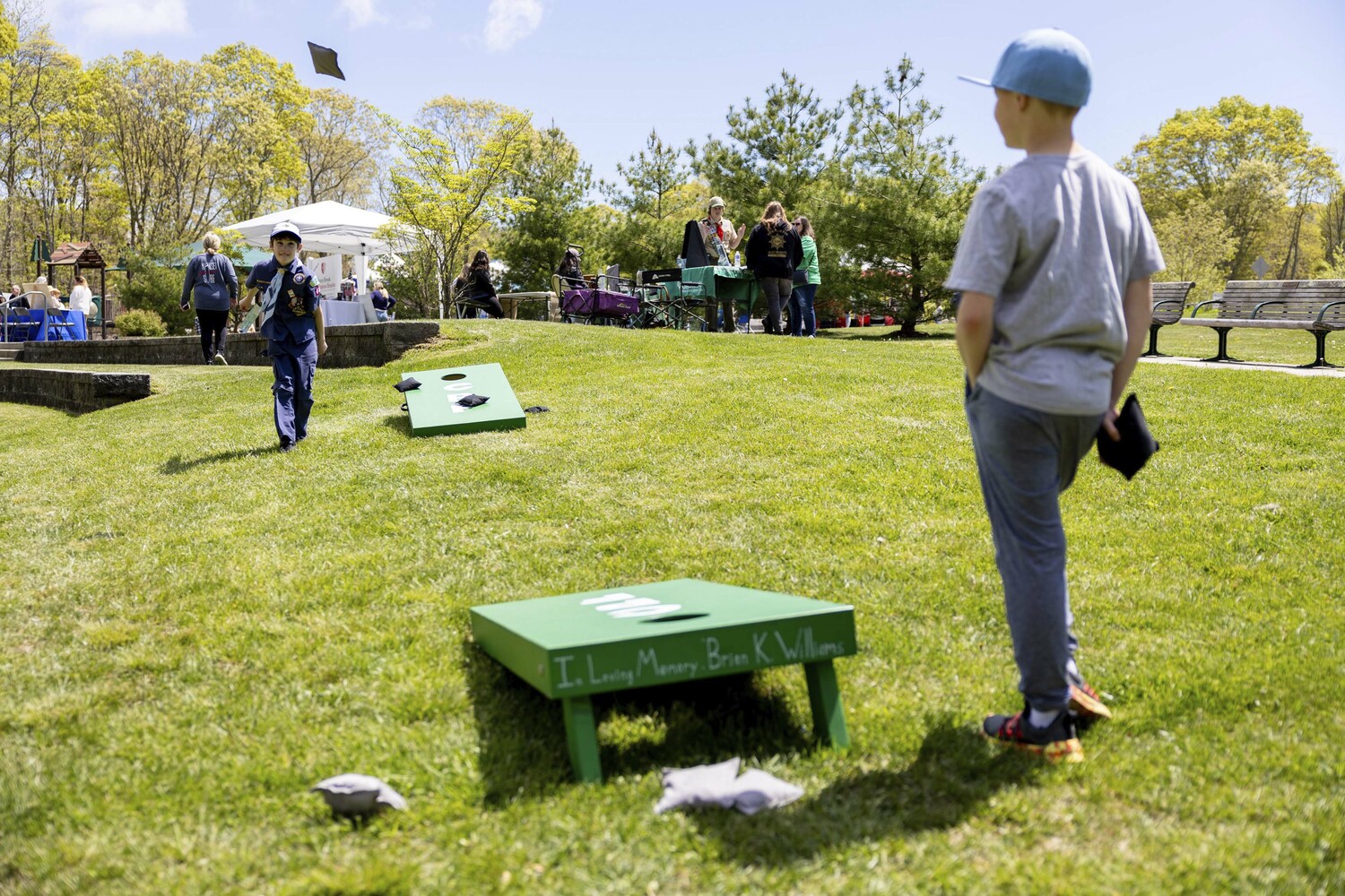 Hampton Bays Cub Scouts Nathan and Dickson play a round of cornhole at the Community Preservation Fund 25th anniversary celebration at Good Ground Park in Hampton Bays on Saturday.  MICHAEL O'CONNOR