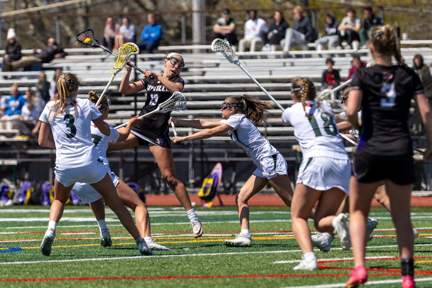 Westhampton Beach players swarm to defend against Sayville during a 9-5 loss on April 26. RON ESPOSITO