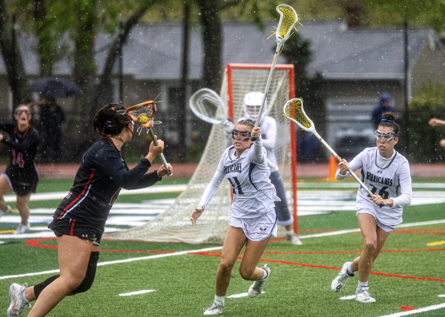 Junior defender Hailey Donahoe and sophomore midfielder Caeden Dorn keep a Mt. Sinai opponent at a distance. MICHAEL O'CONNOR