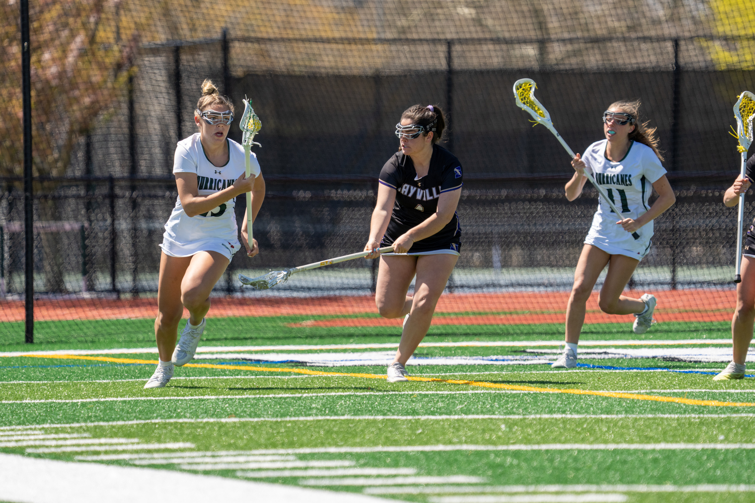 Senior midfielder Katie Lanning carries the ball up the field during a 9-5 loss to Sayville on April 26. RON ESPOSITO