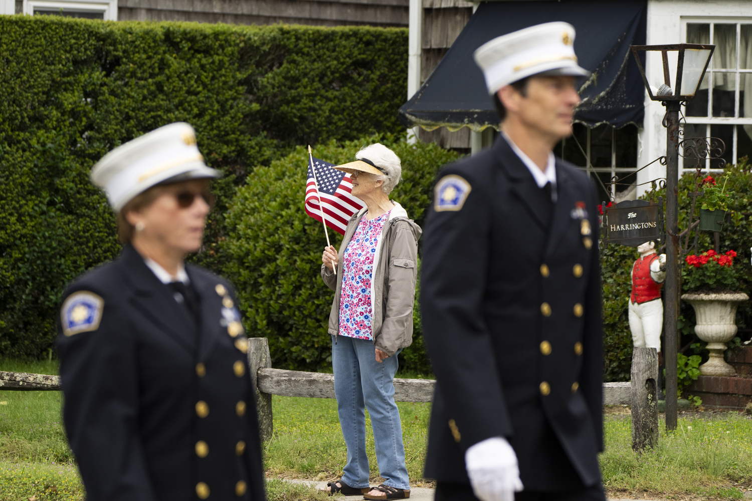 A woman watches the Sag Harbor Memorial Day Parade pass on Main Street. LORI HAWKINS