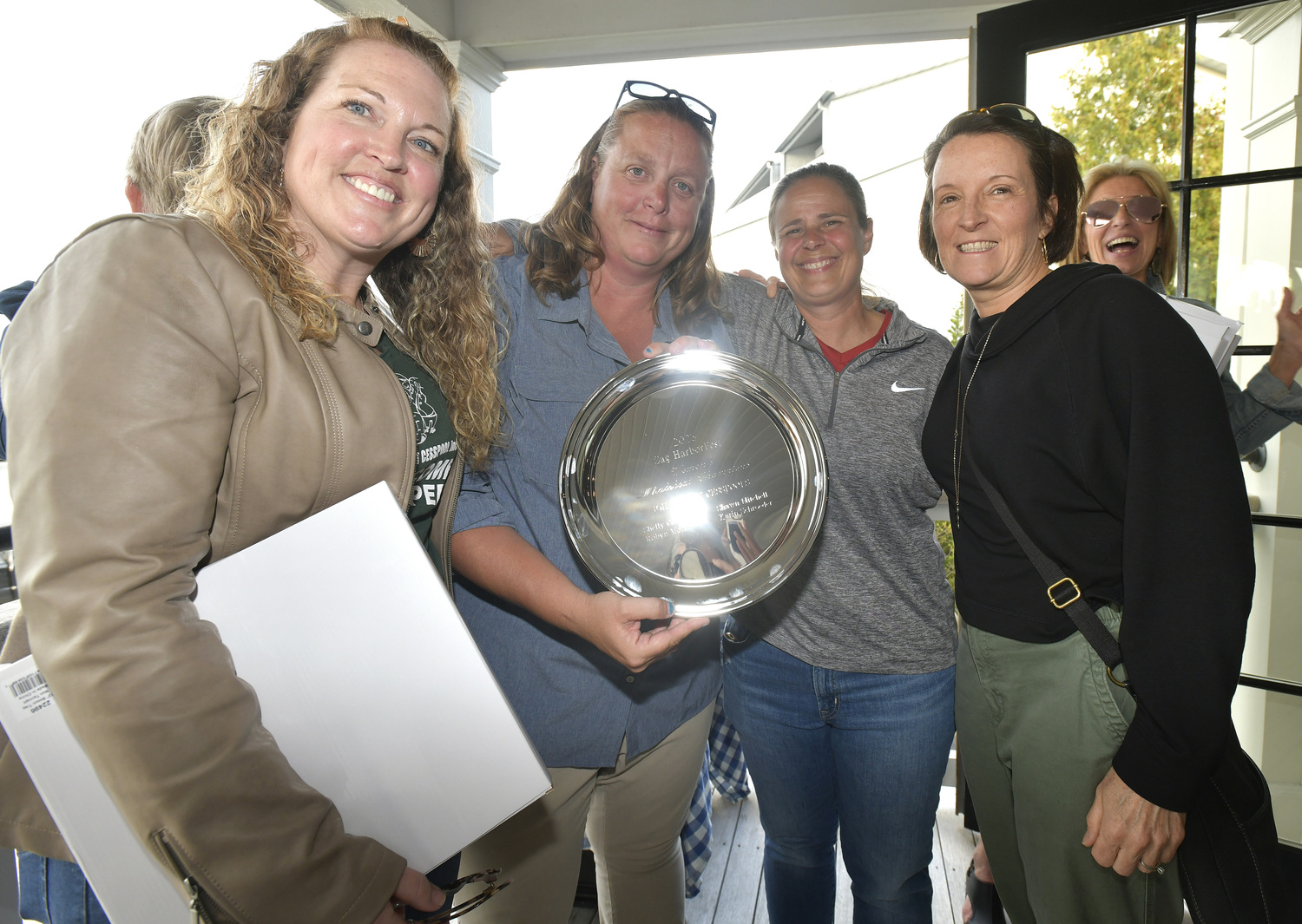 The 2023 Women's Whaleboat champions from John K. Ott Cesspool Service, from left, Shawn Mitchell, Robyn Mott, Shelly Cottrell and Karin Schroeder with their award at the Save the Whale Boats Fundraiser at Baron's Cove in Sag Harbor on April 2.  DANA SHAW
