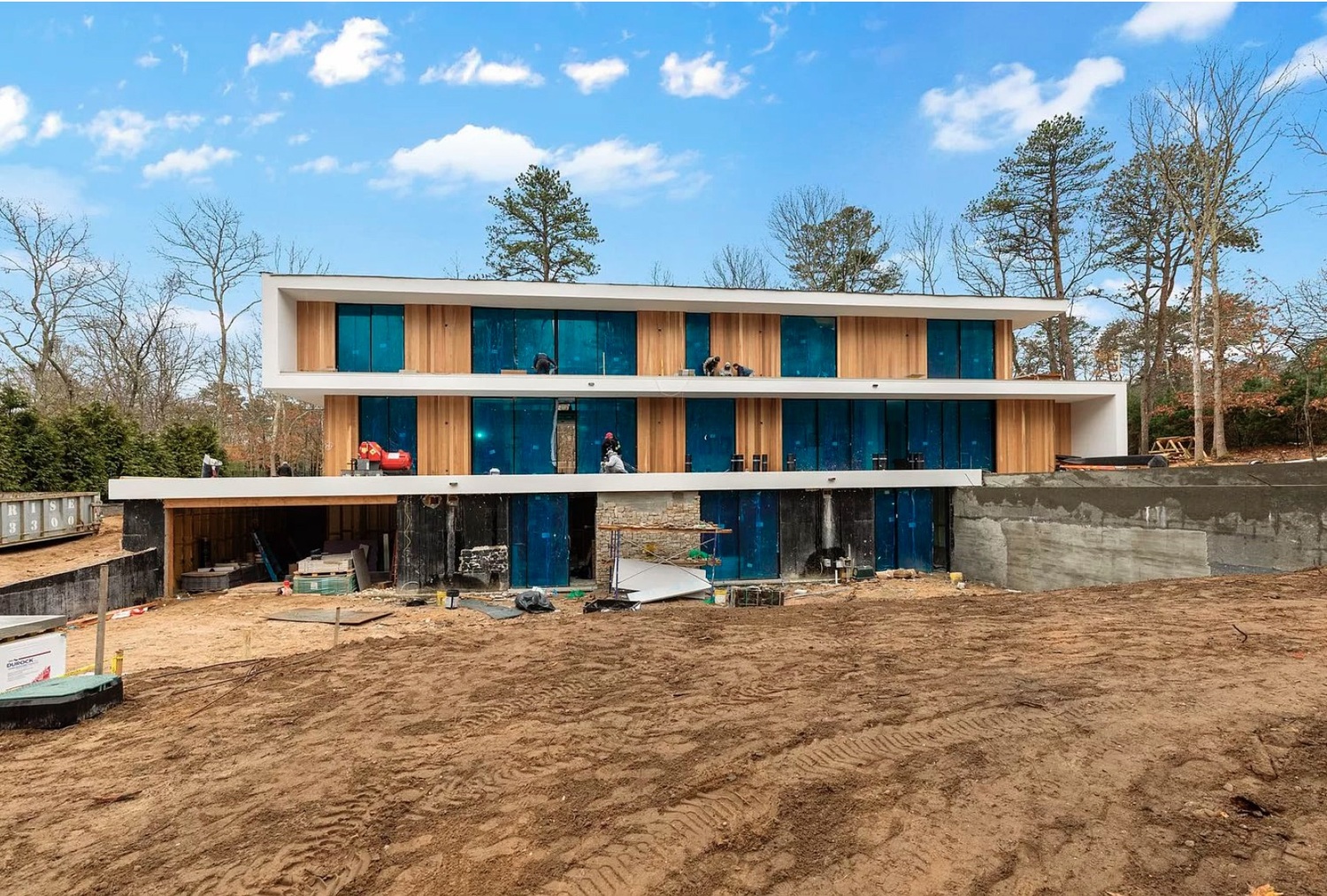 In one example the committee pointed to, an excavated rear yard and retaining walls had allowed a developer to create a lower level that was not counted as part of the house's official size but was essentially a third story. EAST HAMPTON TOWN