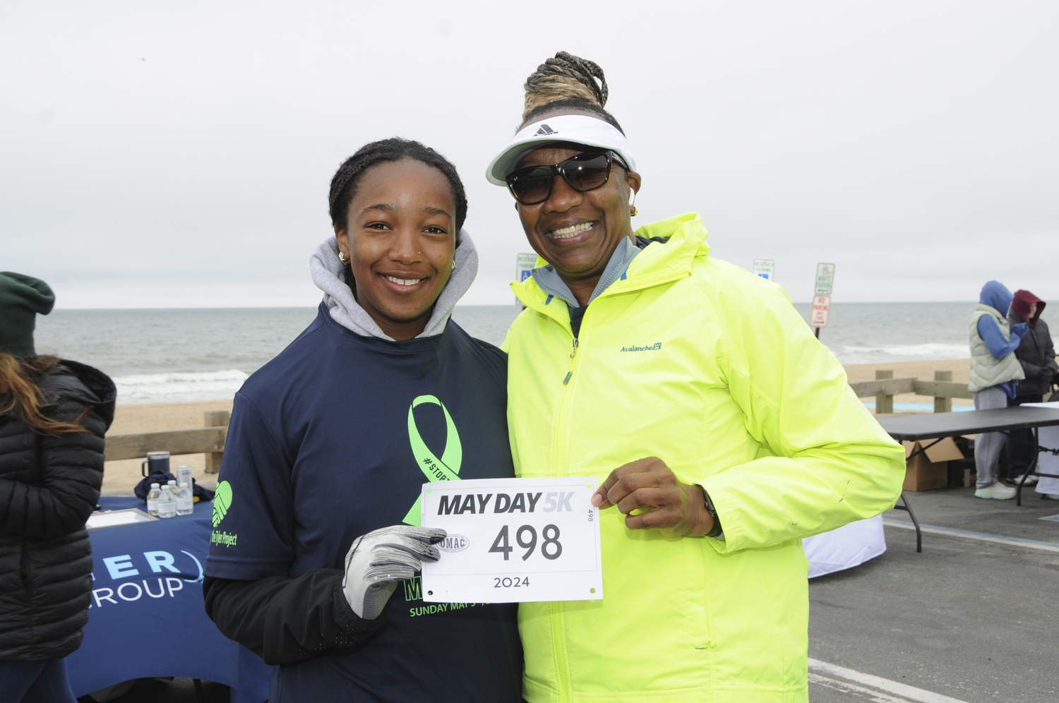 Leslie Samuel and Julianne Moseley at East Hampton's Main Beach early on Sunday morning, to prepare for the start of the annual May Day 5K Run, this year benefiting The Tyler Project (tylerproject.org). Over 900 people signed up for the Run, founded in 2021 by East Hampton High School runners Ryleigh O'Donnell and Dylan Cashin, to coincide with Mental Health Awareness Month. East Hampton Village Mayor Jerry Larsen, Village Administrator Marcos Baladron, Jennifer Fowkes of the Old Montauk Athletic Club and Bradford Billet of the East Hampton Village Foundation provided support for the Run.  RICHARD LEWIN