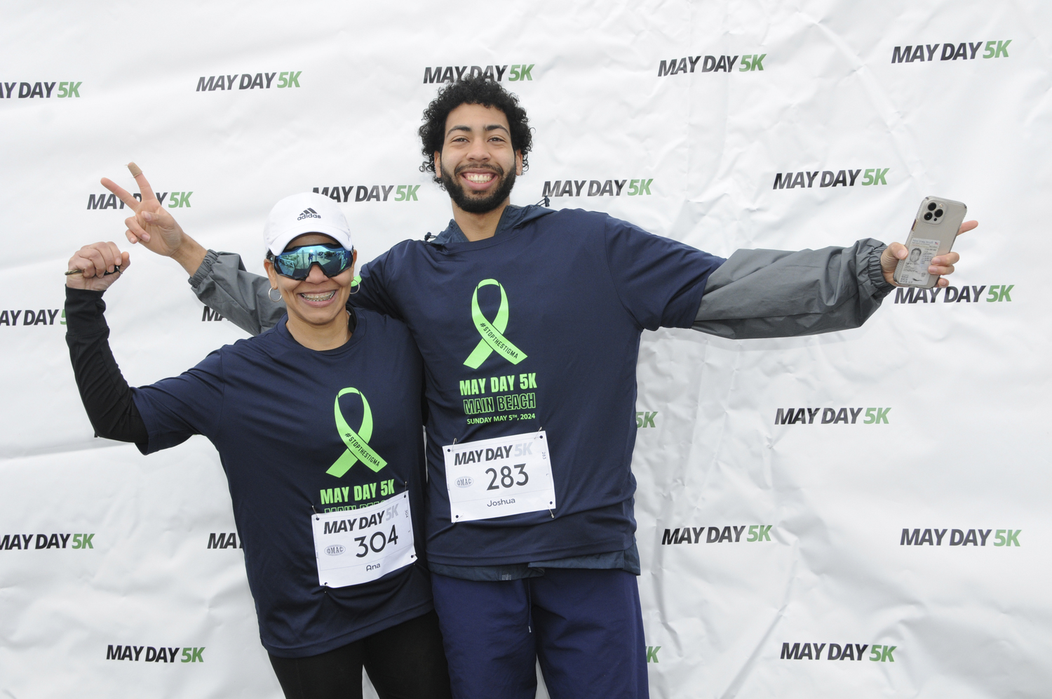 Ana Julia Garcia and Joshua Vargas at East Hampton's Main Beach early on Sunday morning, to prepare for the start of the annual May Day 5K Run, this year benefiting The Tyler Project (tylerproject.org). Over 900 people signed up for the Run, founded in 2021 by East Hampton High School runners Ryleigh O'Donnell and Dylan Cashin, to coincide with Mental Health Awareness Month. East Hampton Village Mayor Jerry Larsen, Village Administrator Marcos Baladron, Jennifer Fowkes of the Old Montauk Athletic Club and Bradford Billet of the East Hampton Village Foundation provided support for the Run.  RICHARD LEWIN