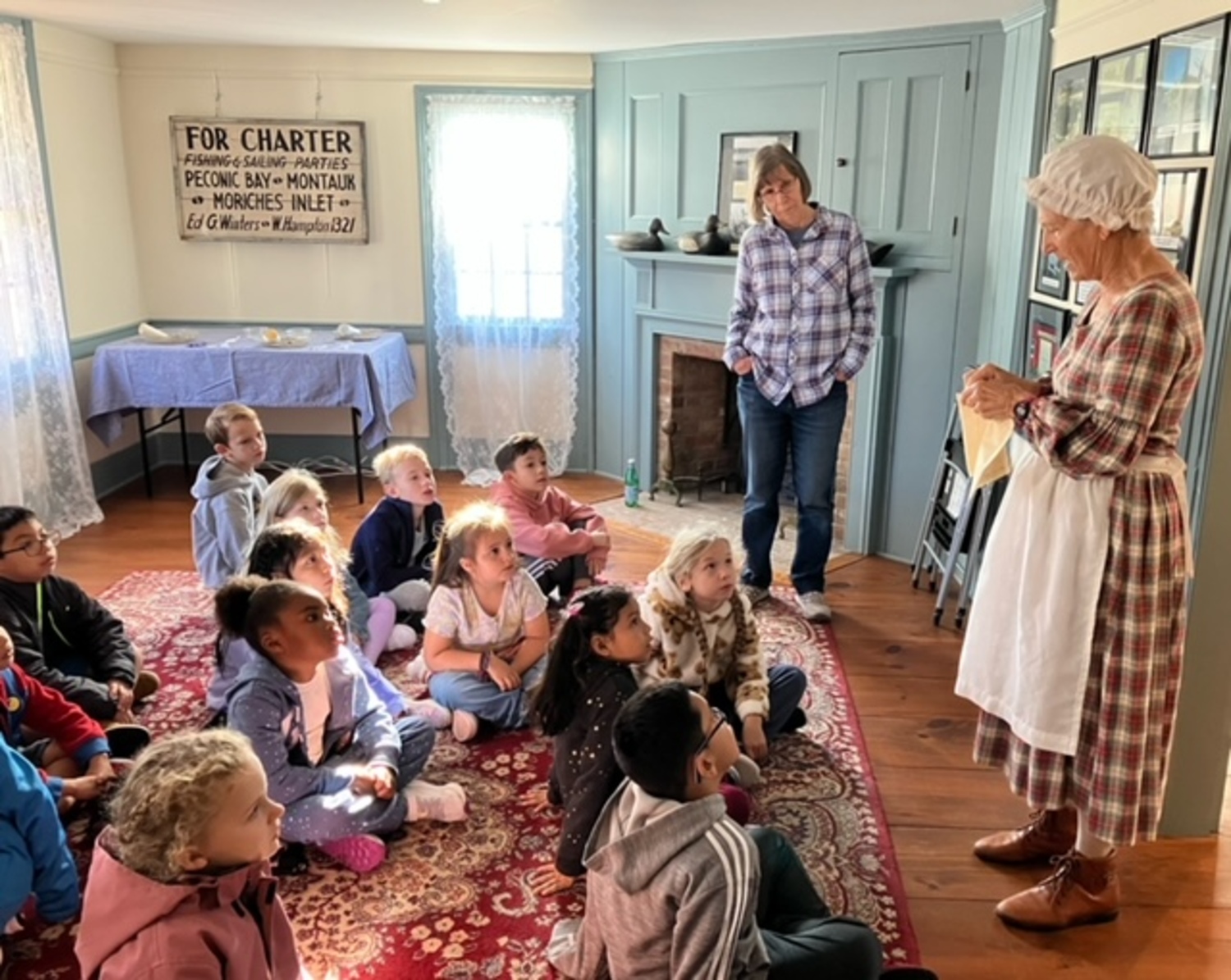 Greater Westhampton Museum Society member Dot Berdinka leads a lesson about Colonial artifacts to second graders at Westhampton Beach Elementary School. COURTESY GREATER WESTHAMPTON MUSEUM SOCIETY