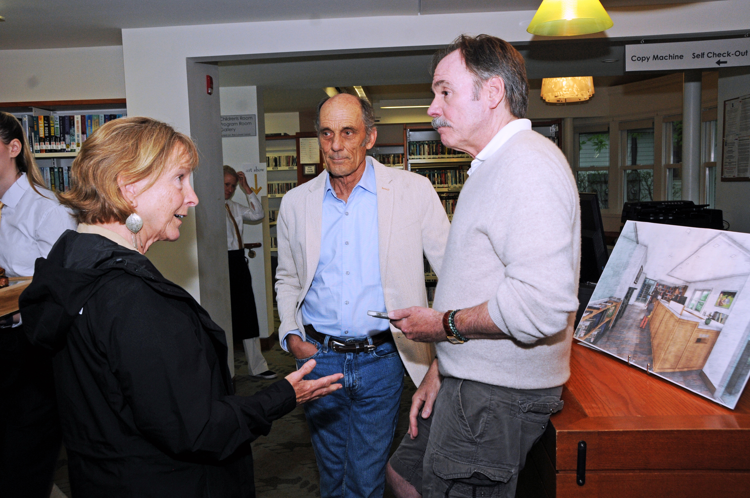 Eva Auchincloss Petersen, Greg Peterson and Fred Schmeltzer at the Hampton Library in Bridgehampton on Saturday evening where the library trustees invited guests to gather at the and see the plans to redesign the library interior. RICHARD LEWIN