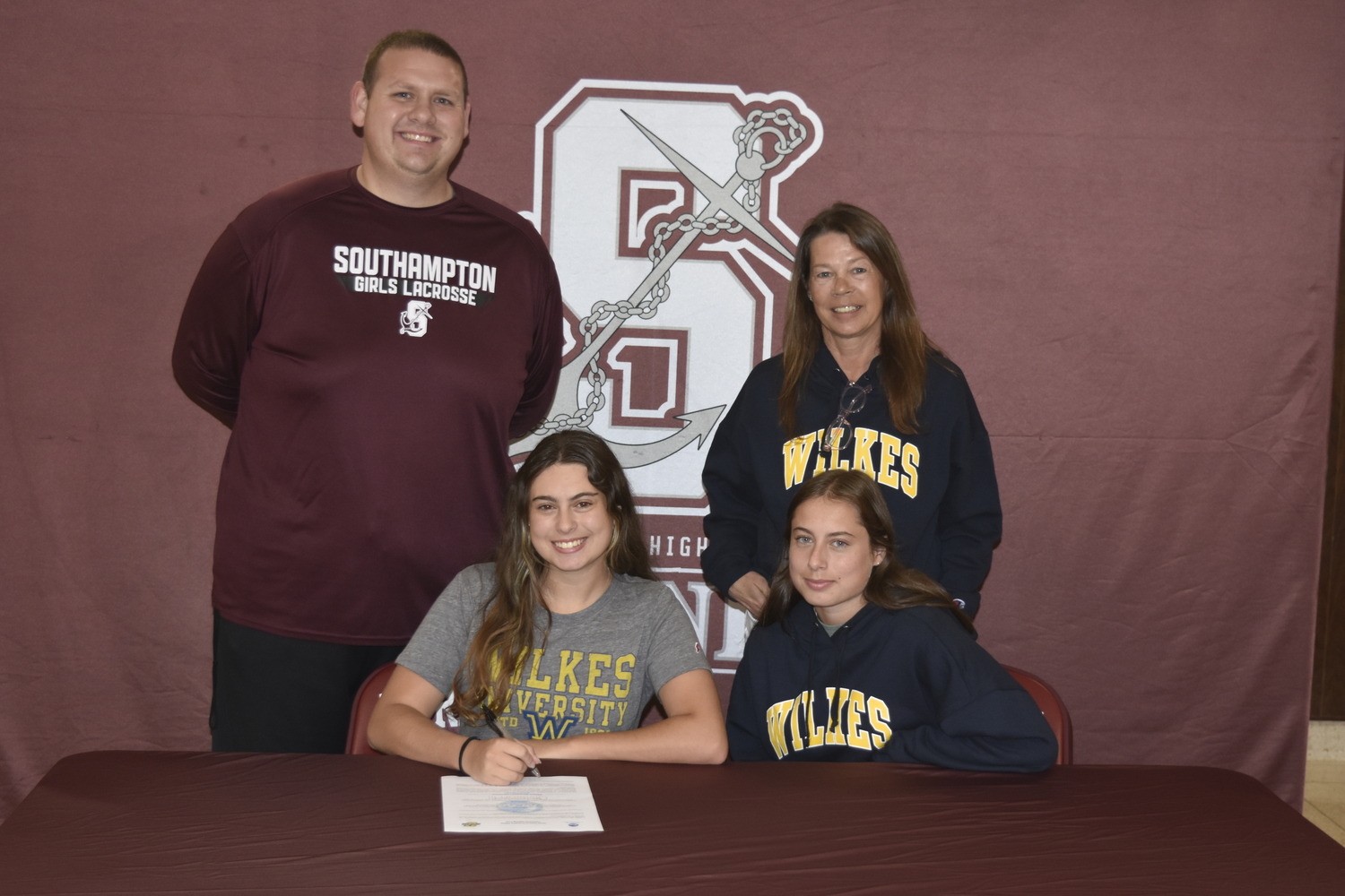 Chloe Bierfriend with varsity girls lacrosse head coach Ryan Sommers, mother Annette Bierfriend and sister Hailey Bierfriend.   DREW BUDD