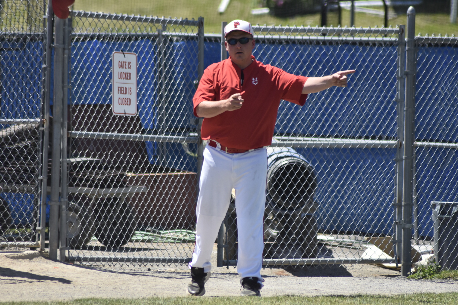 Pierson head coach Bob Manning asks the home plate umpire of the previous pitch location.  DREW BUDD