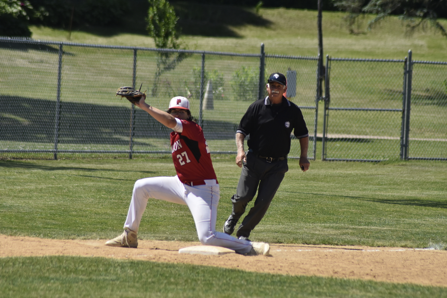 Pierson third baseman Charles Schaefer receives a throw from catcher Jeffrey Gregor with a Burke Catholic player attempting to steal a bag.   DREW BUDD