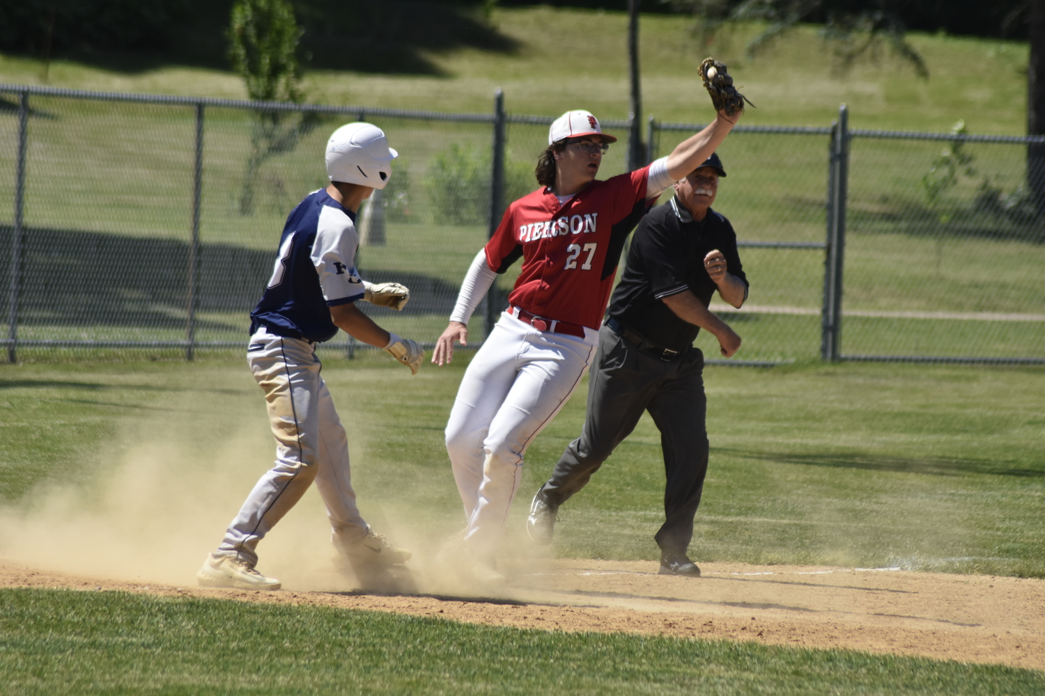 Pierson third baseman Charles Schaefer tags out a Burke Catholic player trying to steal third base.   DREW BUDD
