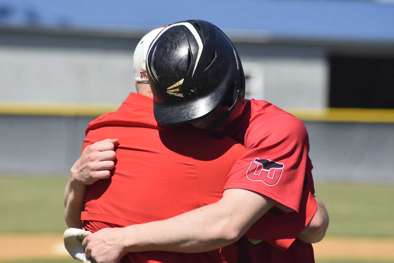 Pierson head coach Bob Manning and senior Nathan Dee hug one another after the final out of Saturday's game.   DREW BUDD