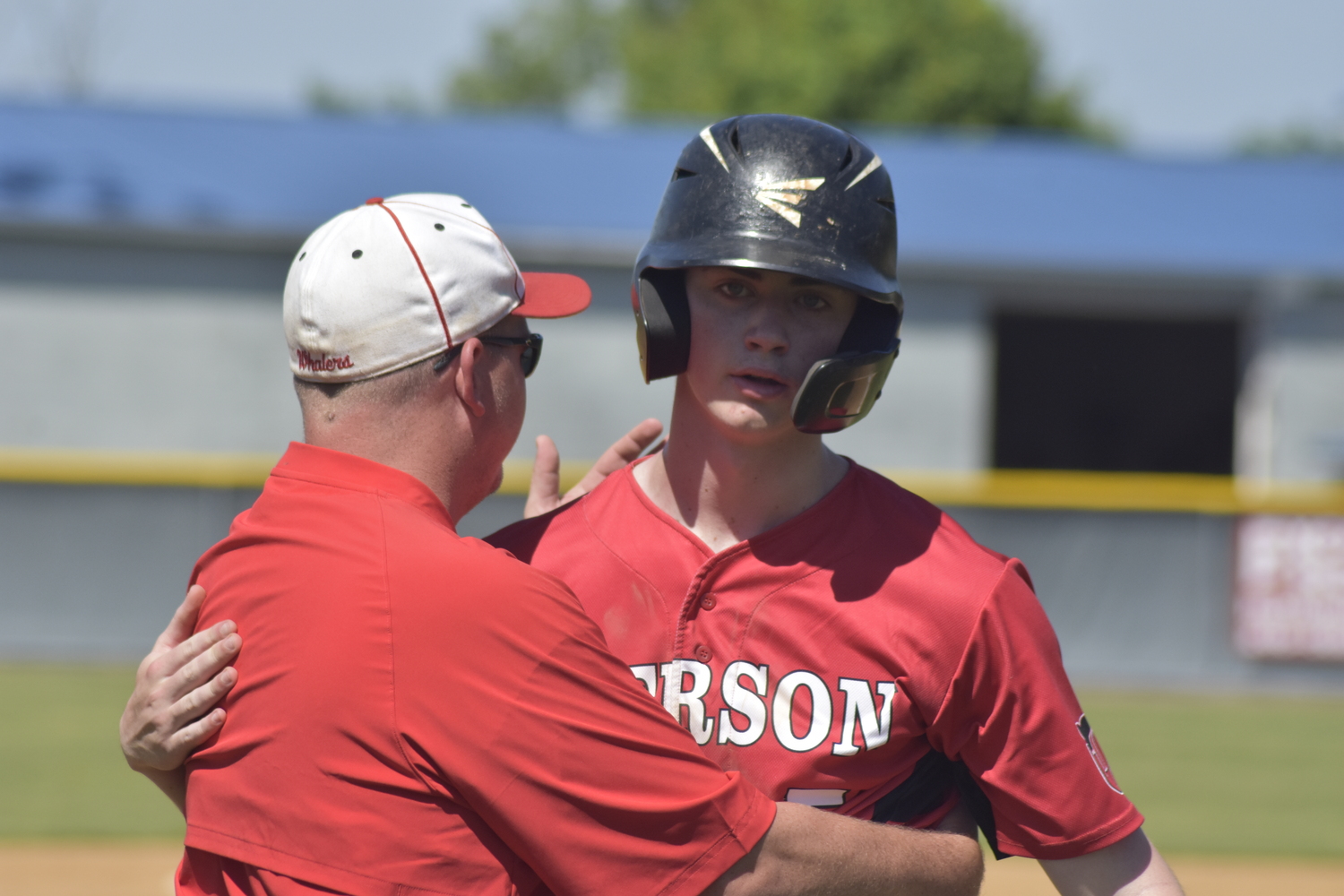 Pierson head coach Bob Manning and senior Nathan Dee hug one another after the final out of Saturday's game.   DREW BUDD