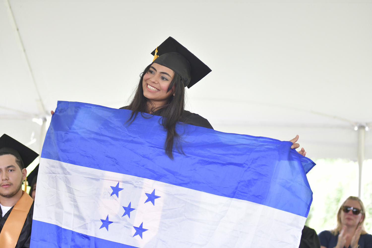 Graduate Ana Chamale Martinez with the Honduran flag.