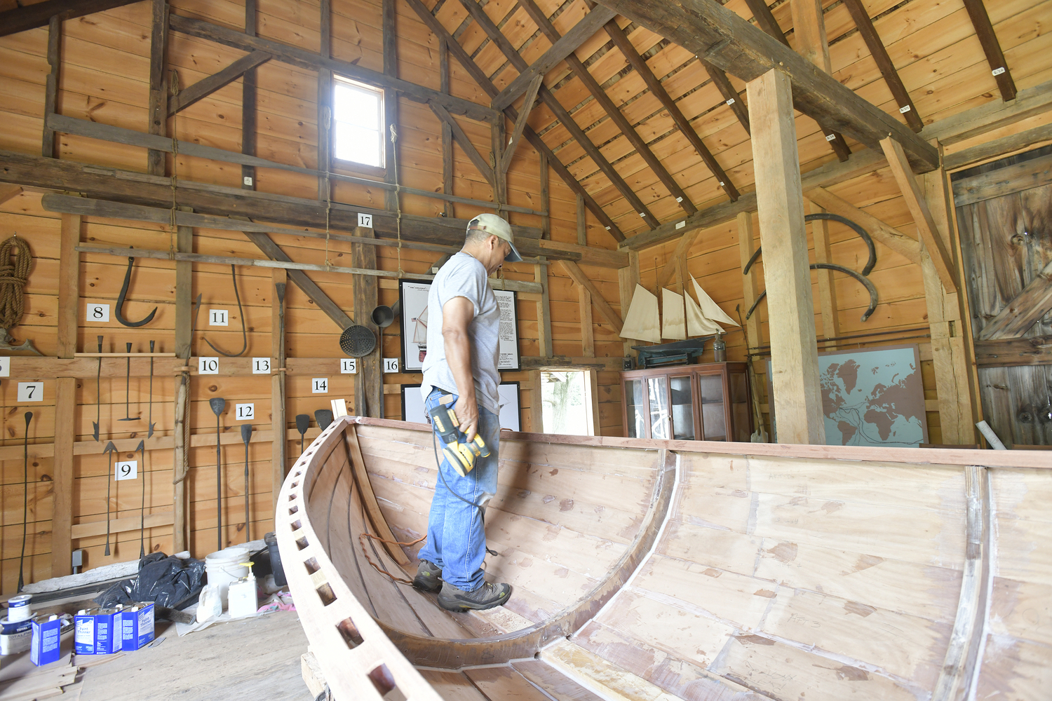 Keith Phillips at work on the Nowedonah at the Southampton Historical Museum.  DANA SHAW