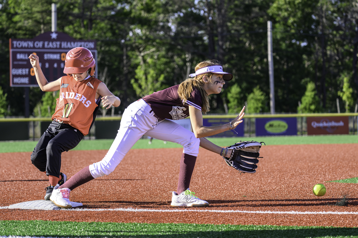 Ann Peterson attempts to catch an incoming throw at third base.  MARIANNE BARNETT
