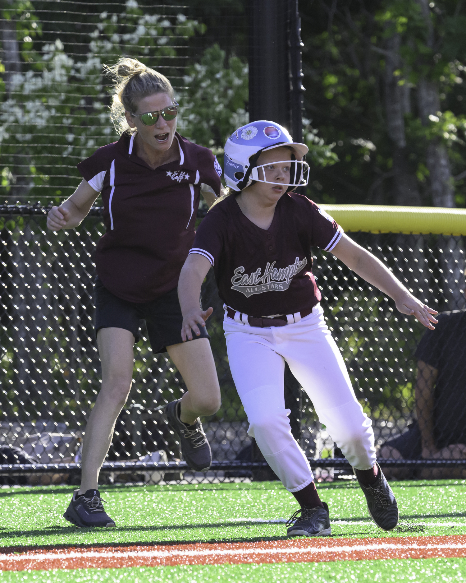 Manager and third base coach Erin Abran tells Madeline Abran to score from third. MARIANNE BARNETT