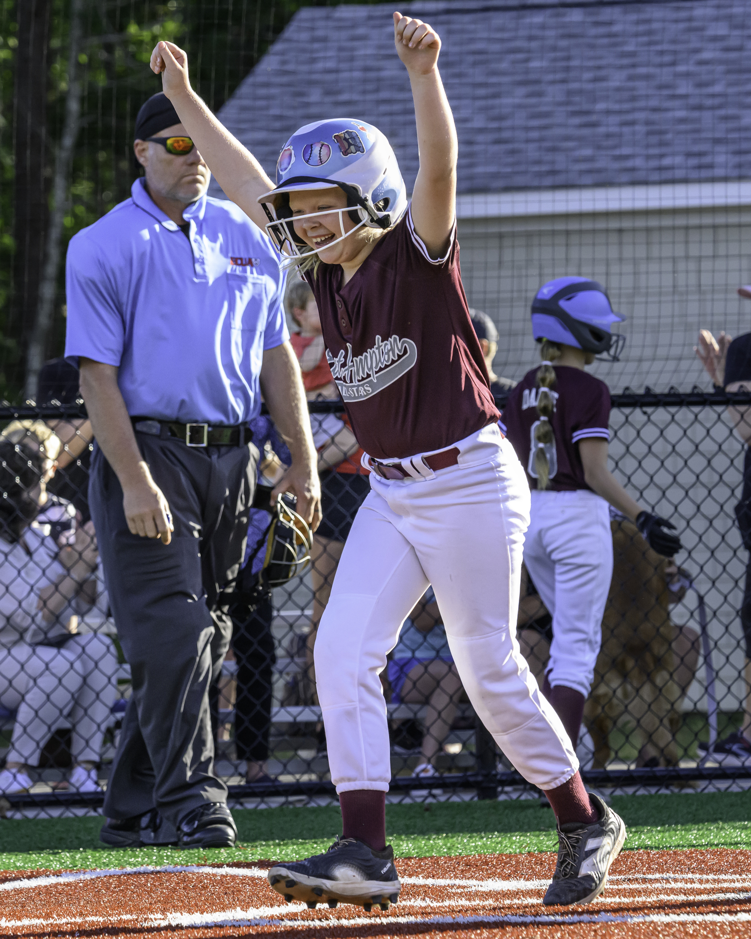Madeline Abran is pumped up after hitting a home run.   MARIANNE BARNETT