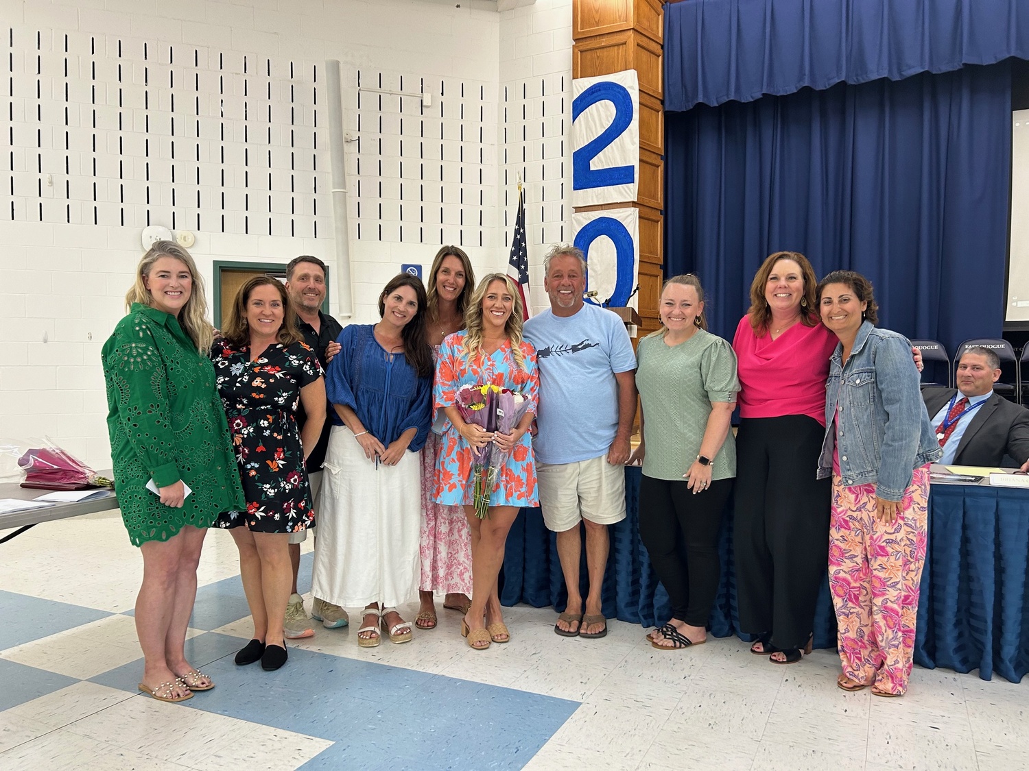 East Quogue School kindergarten teacher Paige Bonner, center, was granted tenure during the June 17  Board of Education meeting. She is surrounded by family and members of the board. COURTESY EAST QUOGUE SCHOOL DISTRICT
